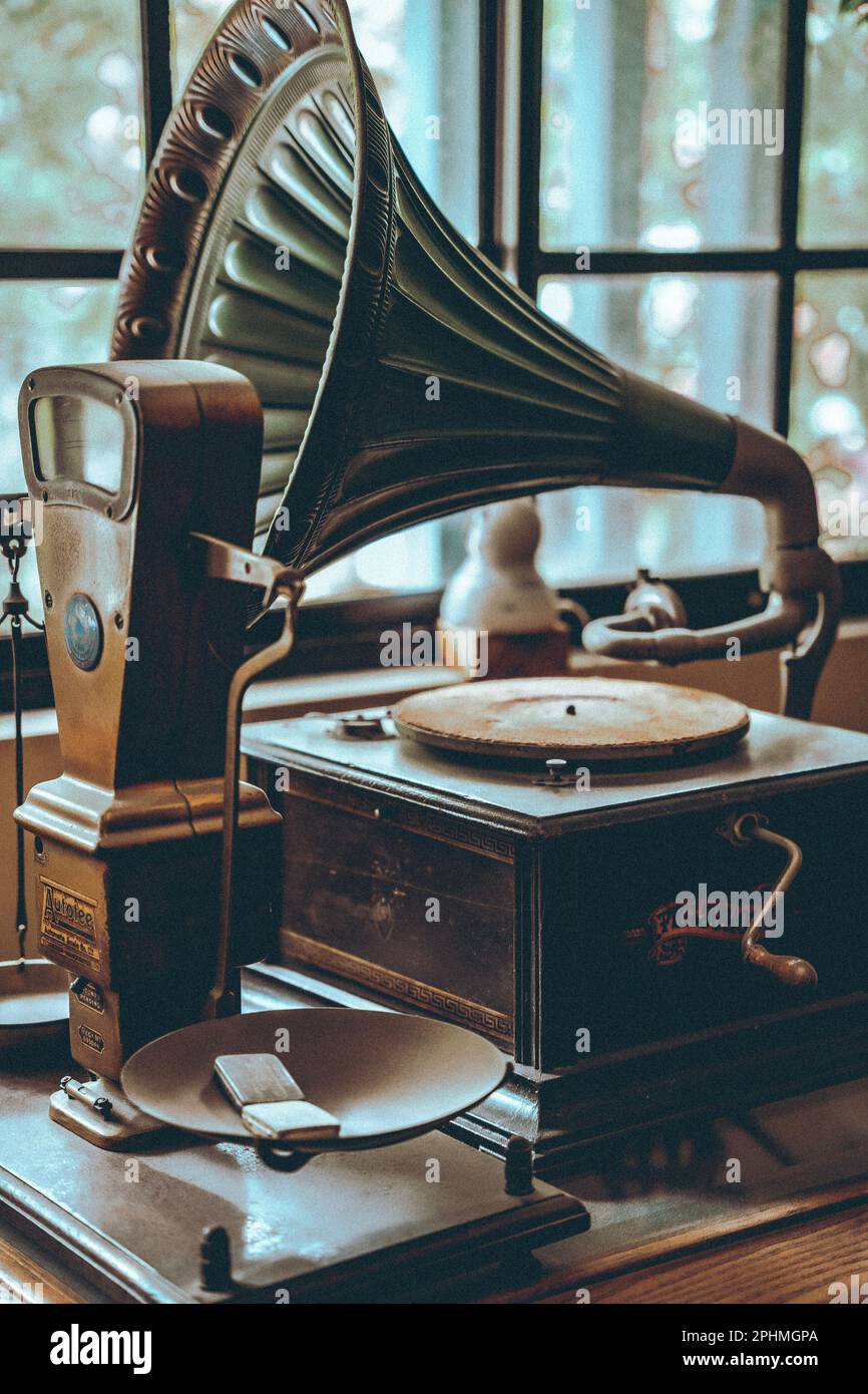 An antique phonograph record player on display in a museum setting