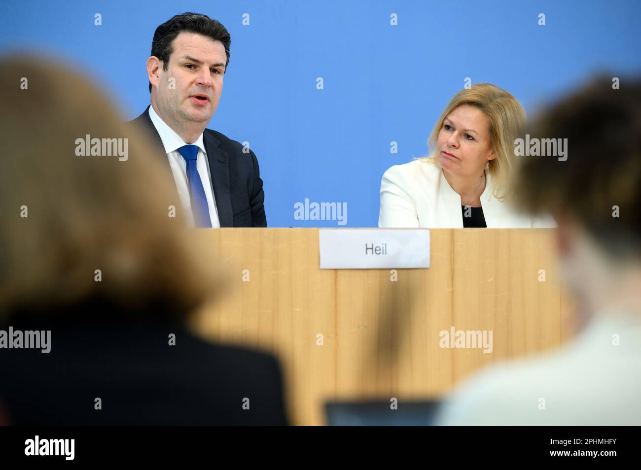 29 March 2023, Berlin: Nancy Faeser (SPD, r), Federal Minister of the Interior and Home Affairs, and Hubertus Heil (SPD), Federal Minister of Labor and Social Affairs, comment on the government's draft of the new Skilled Worker Immigration Act at a press conference after the federal cabinet meeting. Photo: Bernd von Jutrczenka/dpa Stock Photo