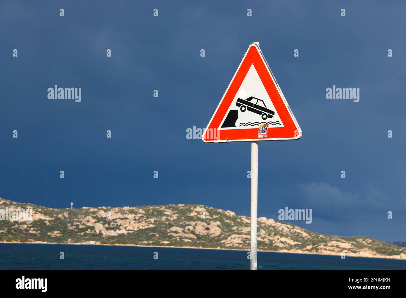 Warning triangle traffic sign of unprotected quayside and danger falling into water - Italy, Sardinia, Europe 2023.03.20 Stock Photo