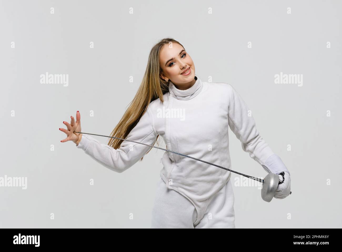 Teen girl in fencing costume with sword in hand isolated on white