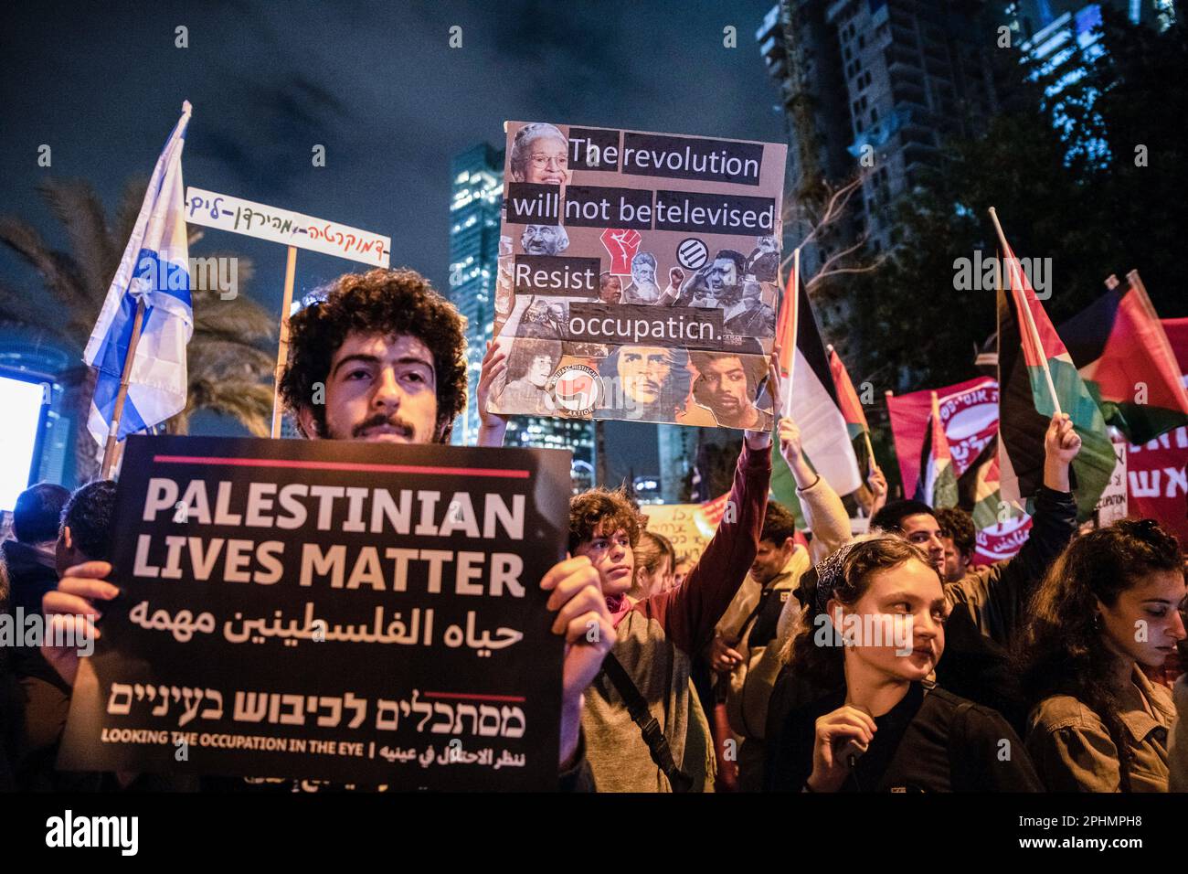 Tel Aviv, Israel. 25th Mar, 2023. Anti-reform activists hold placards against the Israeli occupation of the West Bank during an anti-reform demonstration in Tel Aviv. Over 230,000 people protest in Tel Aviv against Netanyahu's far-right government and its controversial legal reform. Credit: SOPA Images Limited/Alamy Live News Stock Photo