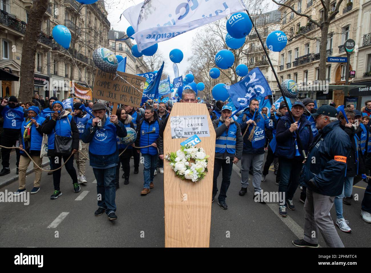 Paris, France. 28th Mar, 2023. A member of the CFTC (French Confederation of Christian Workers) carries a fake coffin that reads 'Caisse de retraite' during a demonstration against pension reform in Paris. President Emmanuel Macron wants to introduce a bill which will raise the retirement age from 62 to 64. (Photo by Lucy North/SOPA Images/Sipa USA) Credit: Sipa USA/Alamy Live News Stock Photo