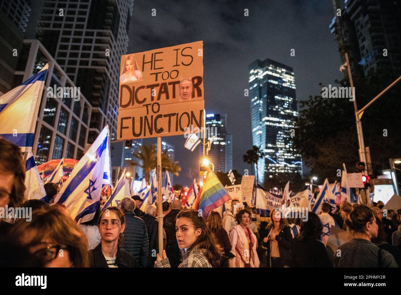 Tel Aviv, Israel. 25th Mar, 2023. Israeli protesters hold a sign that reads Ã¬He is too dictator to functionÃ® during an anti-reform demonstration in Tel Aviv. Over 230,000 people protest in Tel Aviv against Netanyahu's far-right government and its controversial legal reform. (Credit Image: © Matan Golan/SOPA Images via ZUMA Press Wire) EDITORIAL USAGE ONLY! Not for Commercial USAGE! Stock Photo