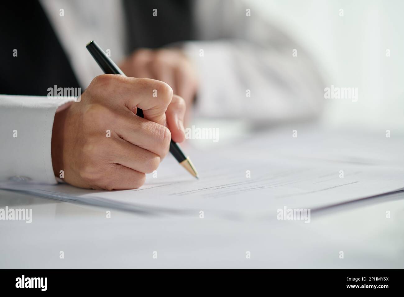 Closeup image of social working signing document Stock Photo