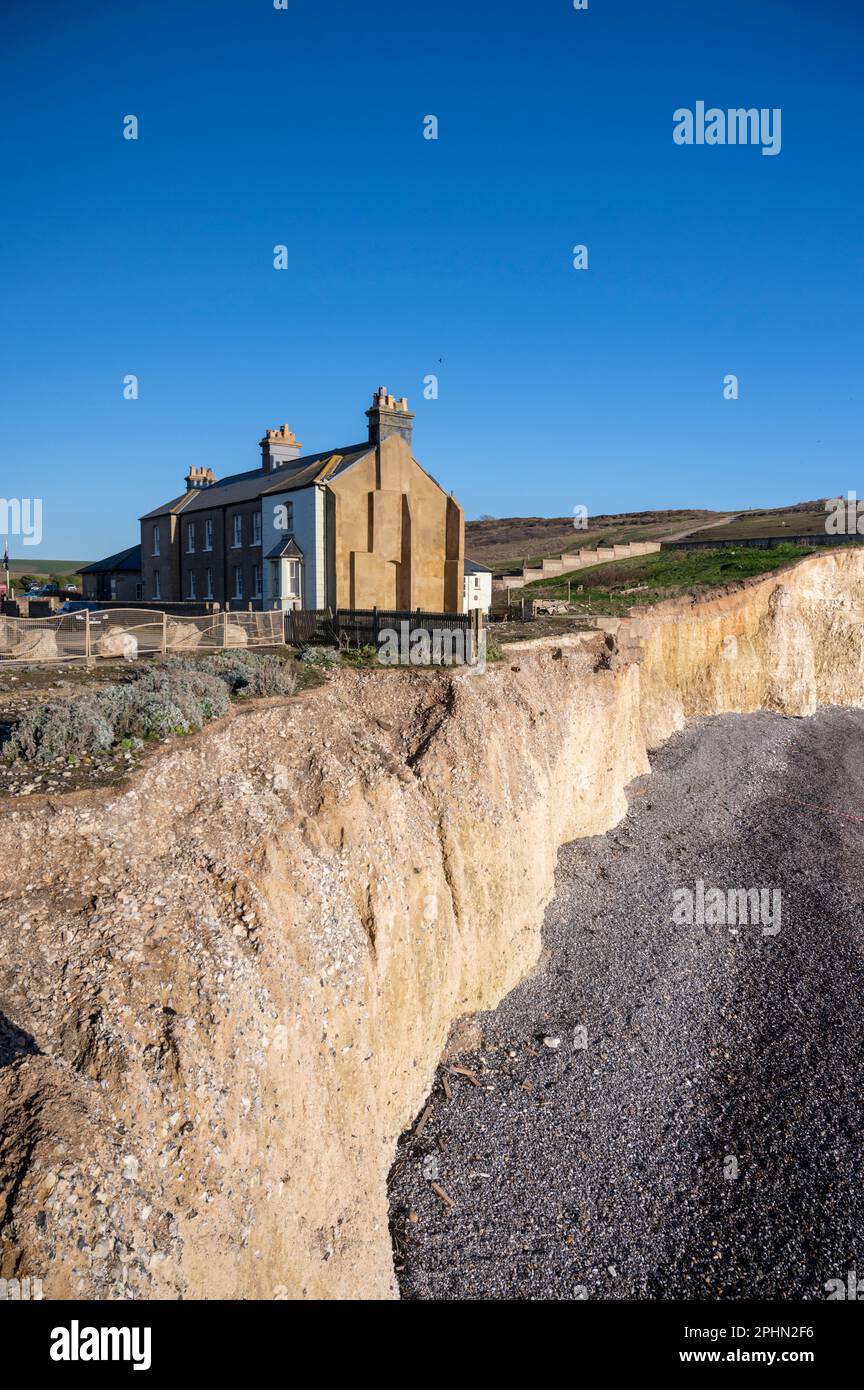The coastguard cottages at Birling Gap on the edge of a cliff which is subject to coastal erosion abnd will be washed in to the sea. Stock Photo