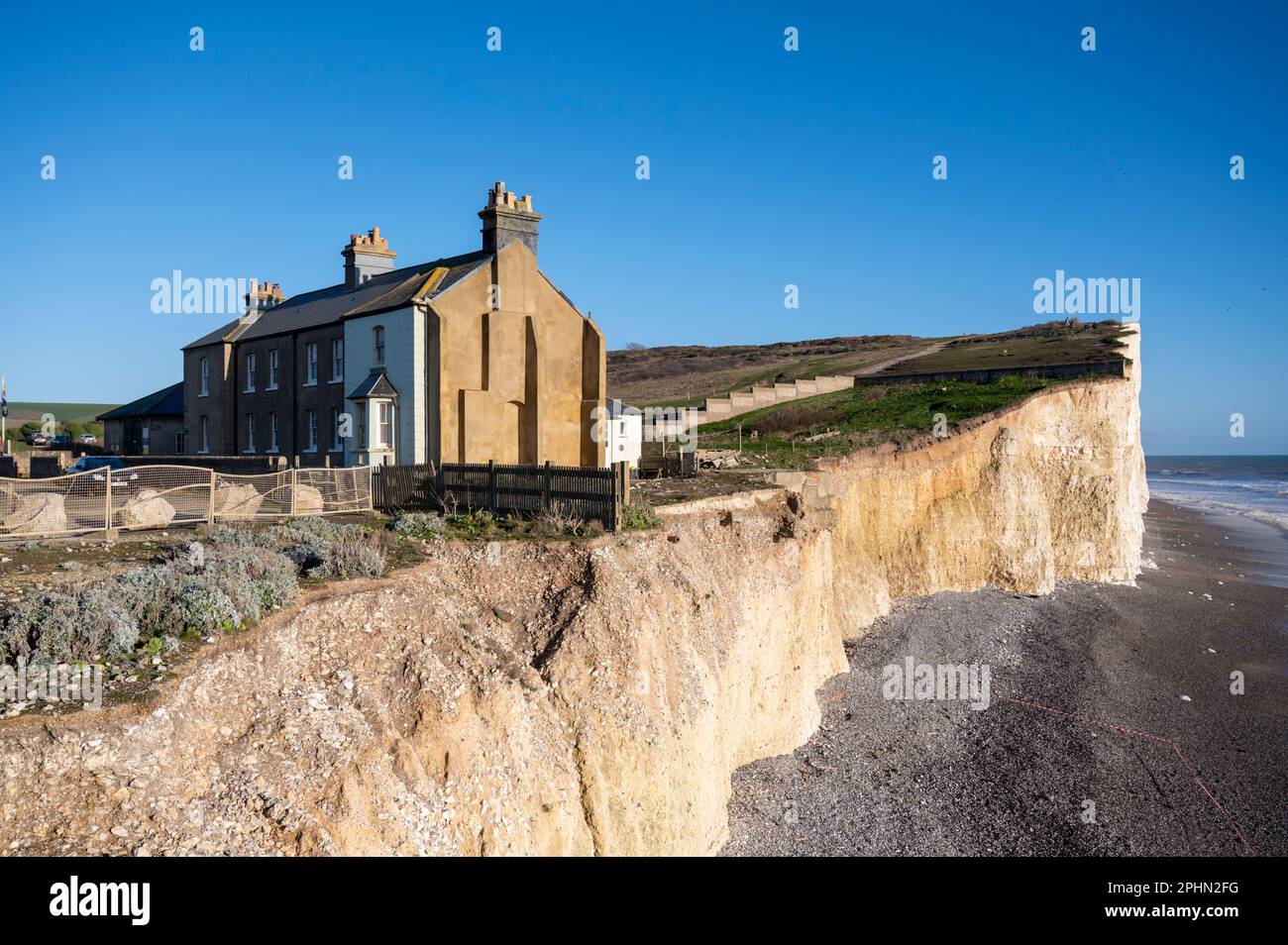 The coastguard cottages at Birling Gap on the edge of a cliff which is subject to coastal erosion abnd will be washed in to the sea. Stock Photo