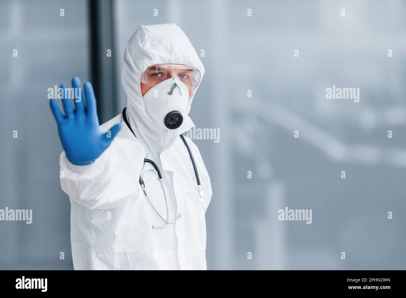 Shows stop gesture by hand. Male doctor scientist in lab coat ...