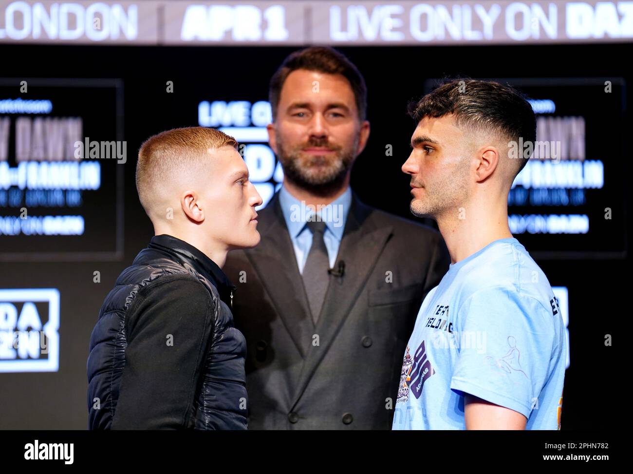 Boxing promoter Eddie Hearn stands in the centre as Campbell Hatton (left) and Louis Fielding face off during a press conference at Nobu Hotel London Portman Square, London. Picture date: Wednesday March 29, 2023. Stock Photo