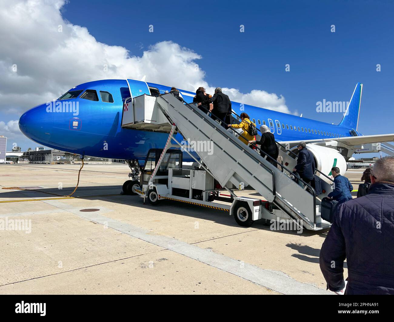 airplane ready for departure with passengers boarding flight Stock
