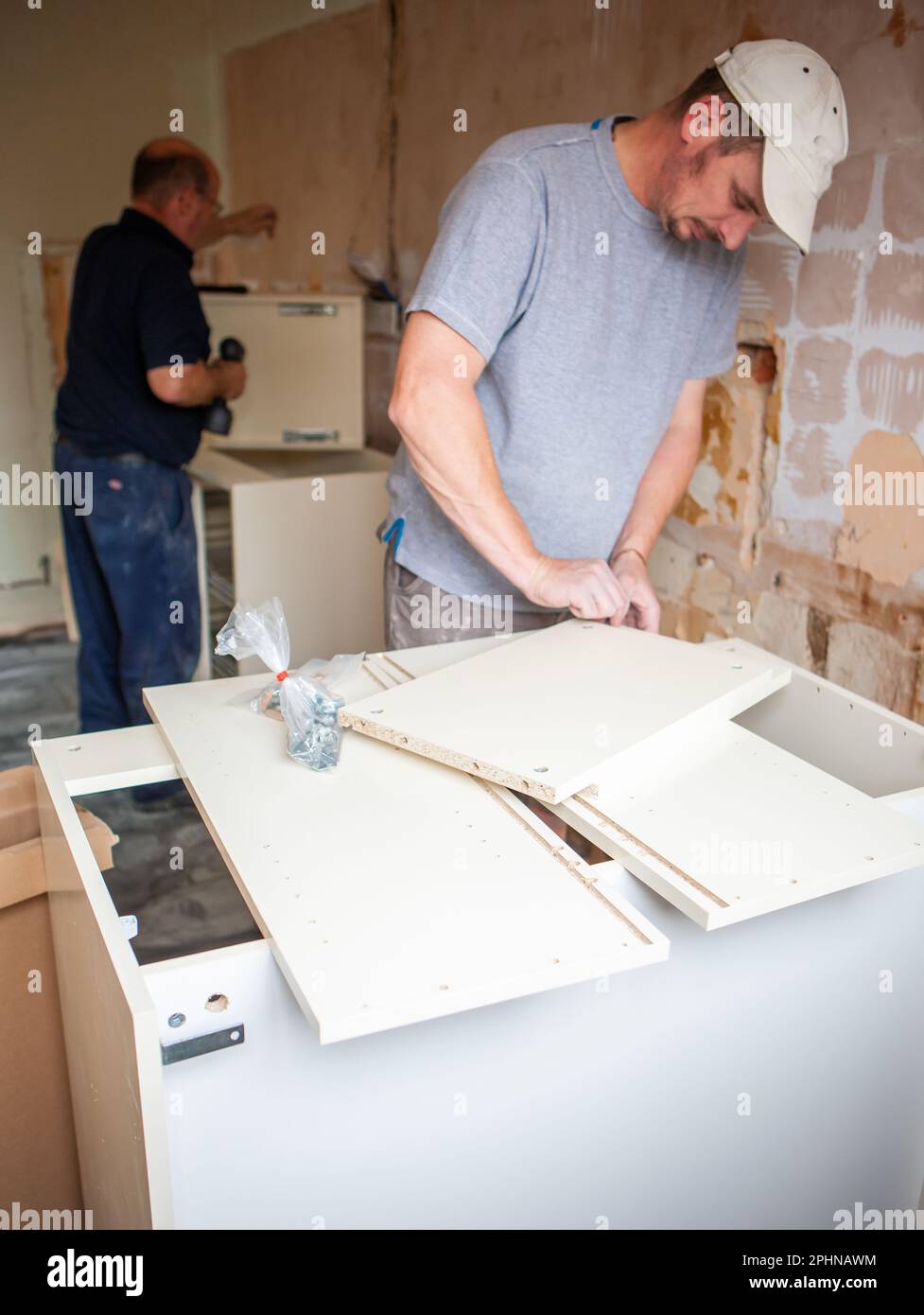 Kitchen Fitters Flat Pack Build. A pair of carpenters building the