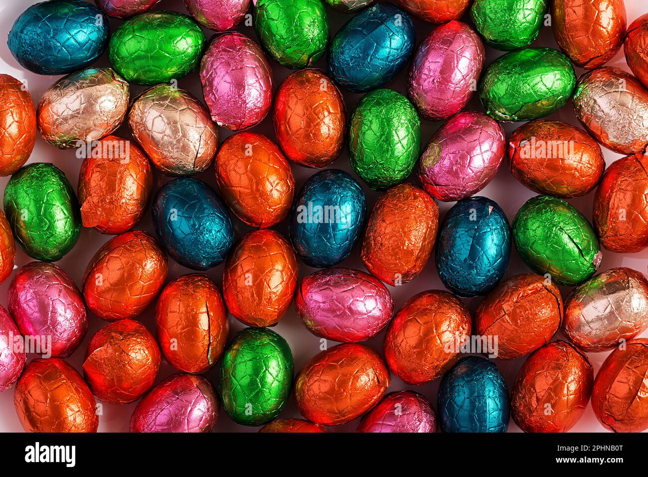Colorful Easter eggs background. Chocolate Easter eggs texture. Top view Stock Photo