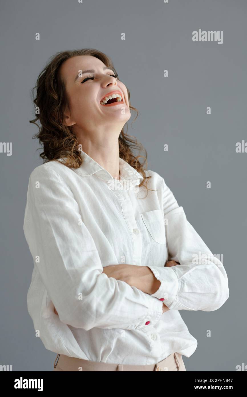 Happy mature woman throwing head back laughing Stock Photo Alamy