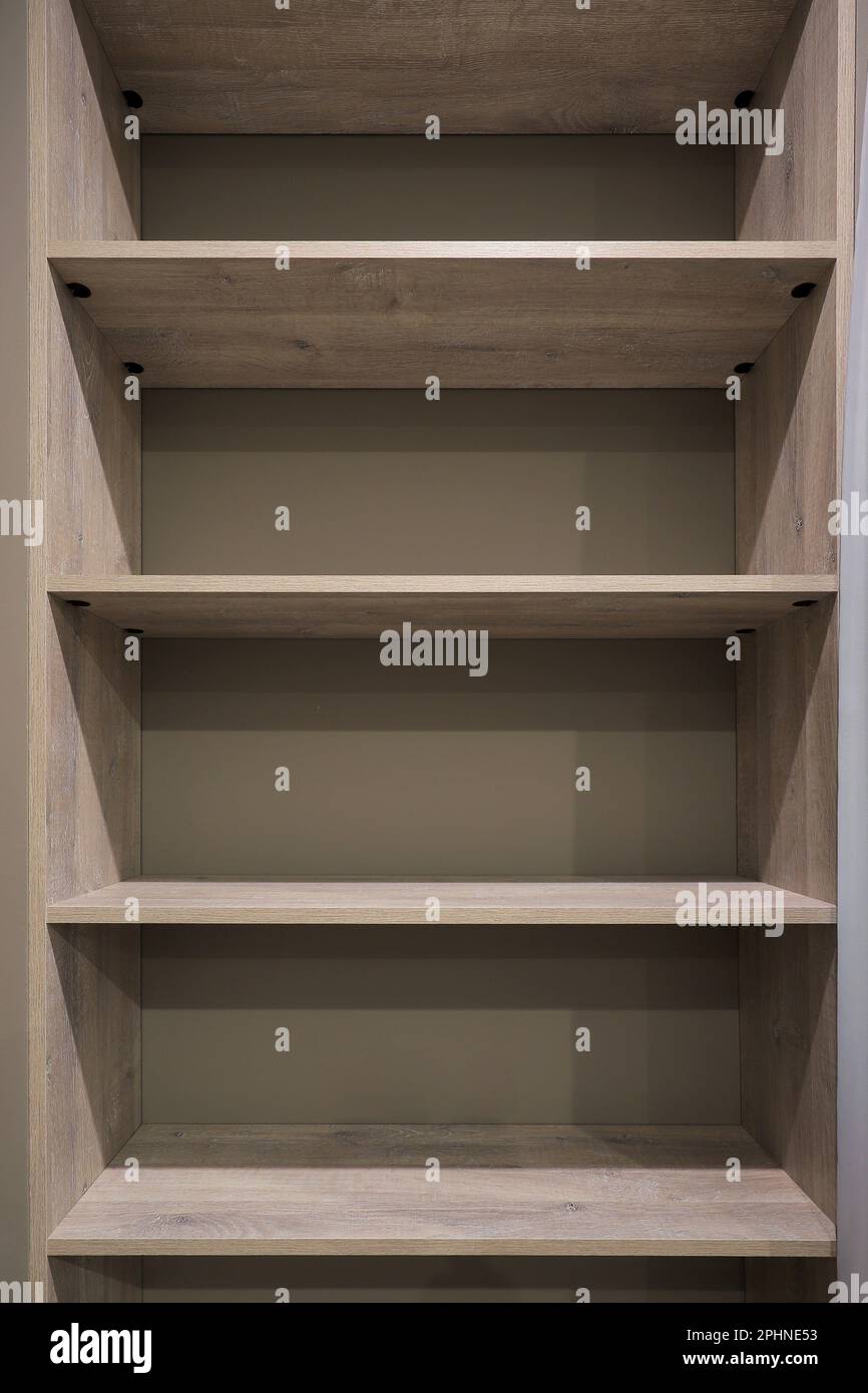 Empty wooden shelves on the wall Stock Photo