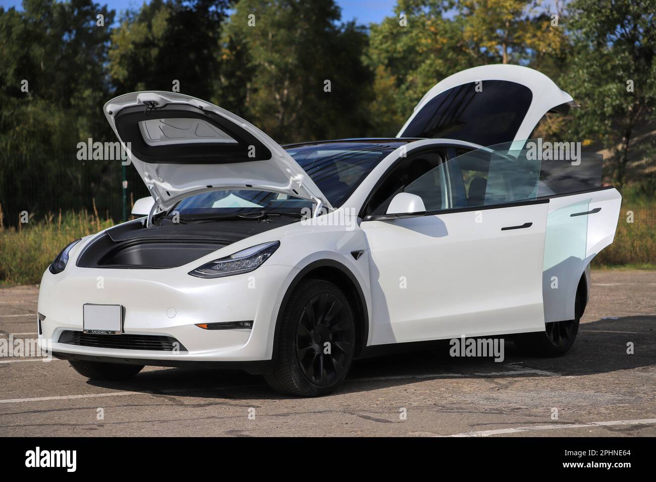 White car Tesla Model Y with open doors Stock Photo Alamy