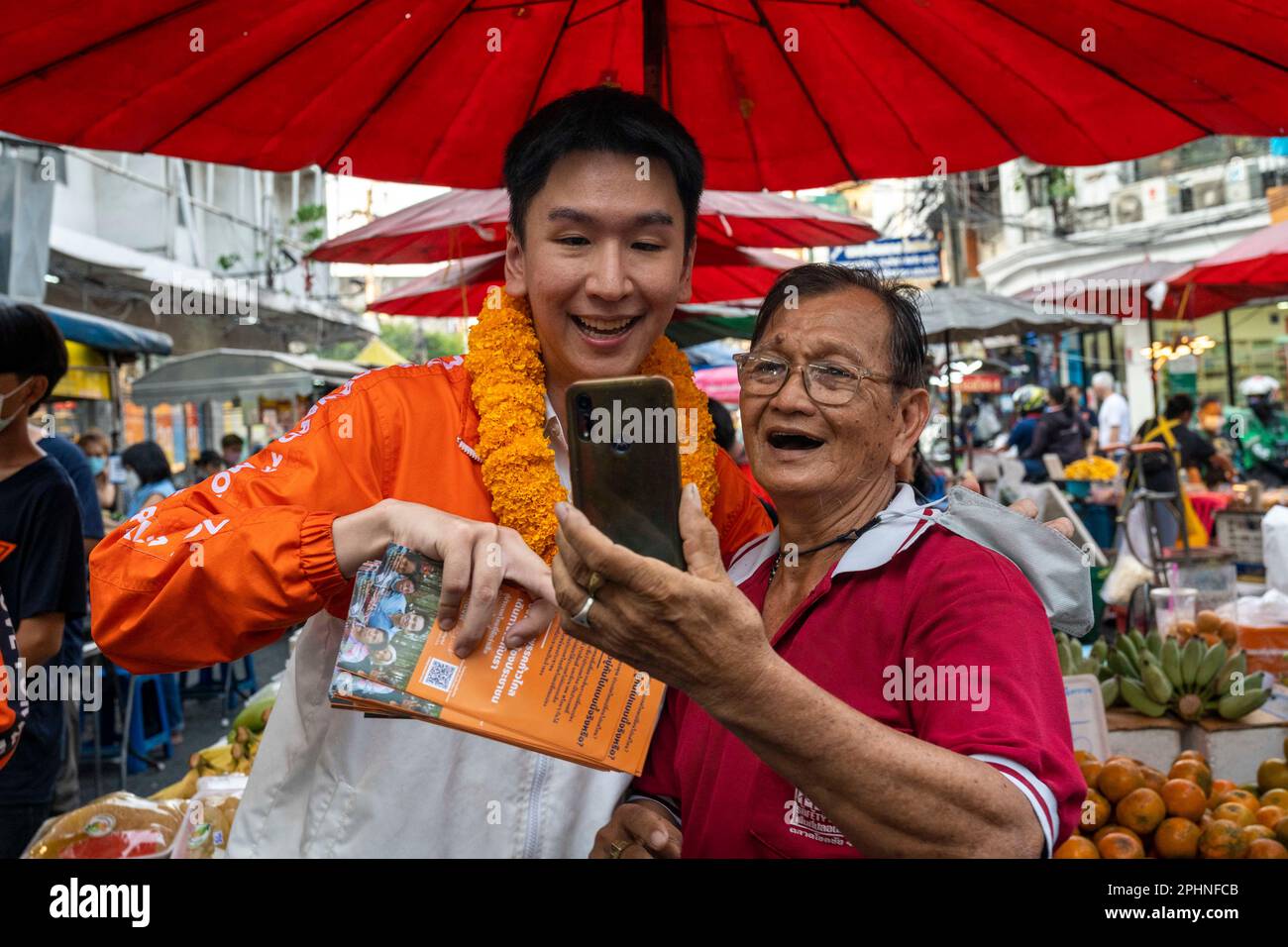 Bangkok, Bangkok, Thailand. 29th Mar, 2023. Move Forward party local representative candidate Chalermchai Kulalert takes a photo with a supporter while canvassing for votes in a market in the Lat Prao district of the Thai capital Bangkok. Thailand's upcoming elections scheduled for May 14th, 2023 will be the nation's first general election since 2019. (Credit Image: © Adryel Talamantes/ZUMA Press Wire) EDITORIAL USAGE ONLY! Not for Commercial USAGE! Stock Photo