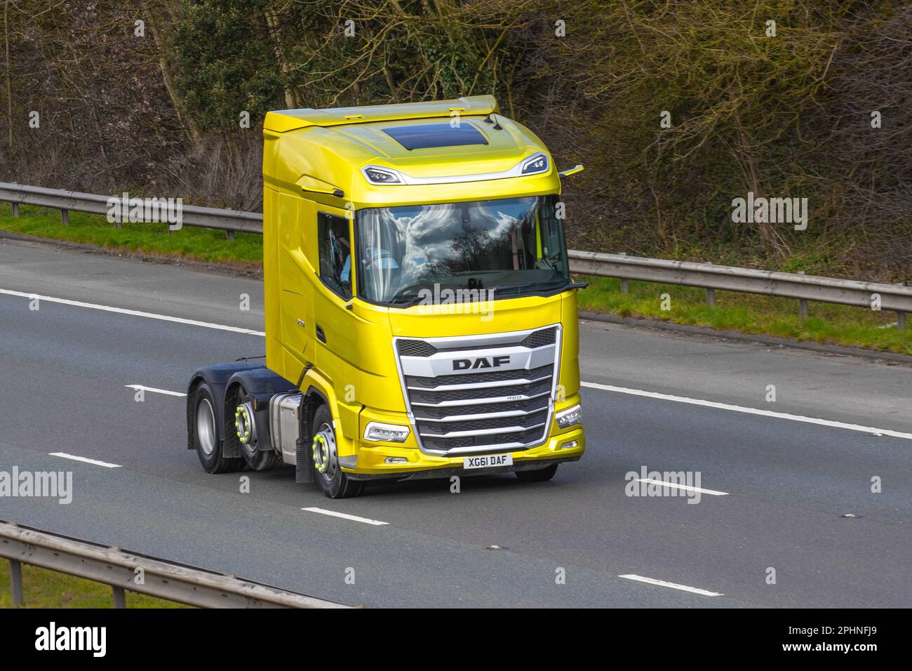 Yellow Gold DAF 510FTT Haulage delivery trucks, lorry, heavy-duty vehicles, transportation, DAF tractor unit truck, cargo carrier, 12902cc  vehicle, European commercial transport industry HGV, M6 at Manchester, UK Stock Photo
