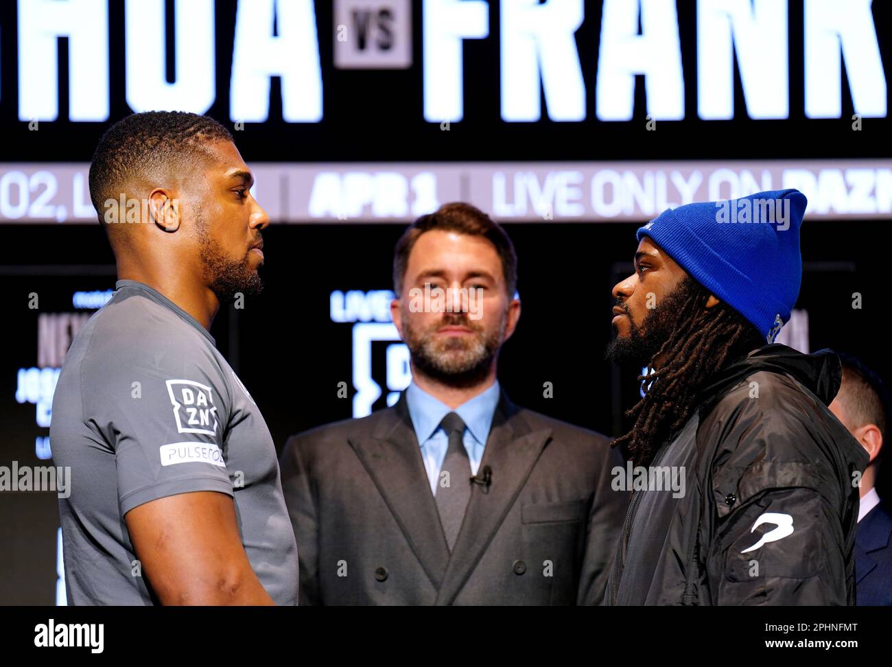Boxing promoter Eddie Hearn stands in the centre as Anthony Joshua and Jermaine Franklin face off during a press conference at Nobu Hotel London Portman Square, London. Picture date: Wednesday March 29, 2023. Stock Photo