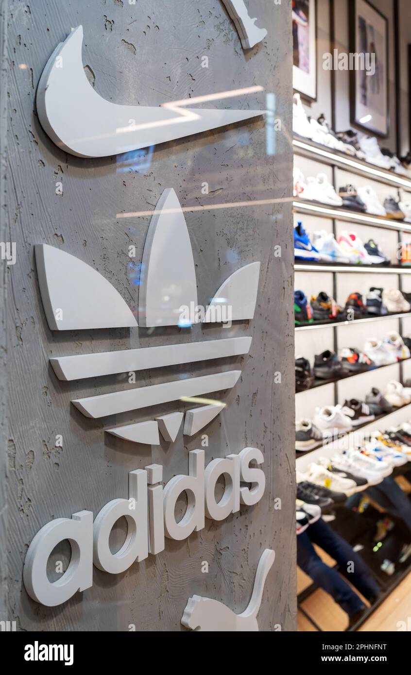 Nike and Adidas Logos of popular footwear and clothing brands in the interior of a multi-brand sport store. Minsk, Belarus, 2023 Stock Photo