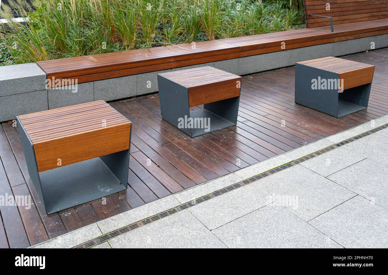 New modern bench in park. Outdoor city architecture, wooden benches