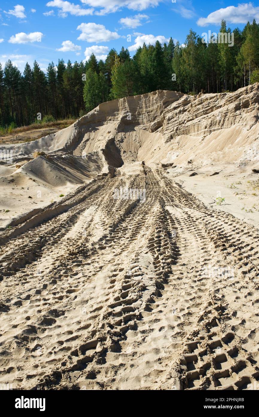 Excavator tire tracks on sand quarry. Stock Photo