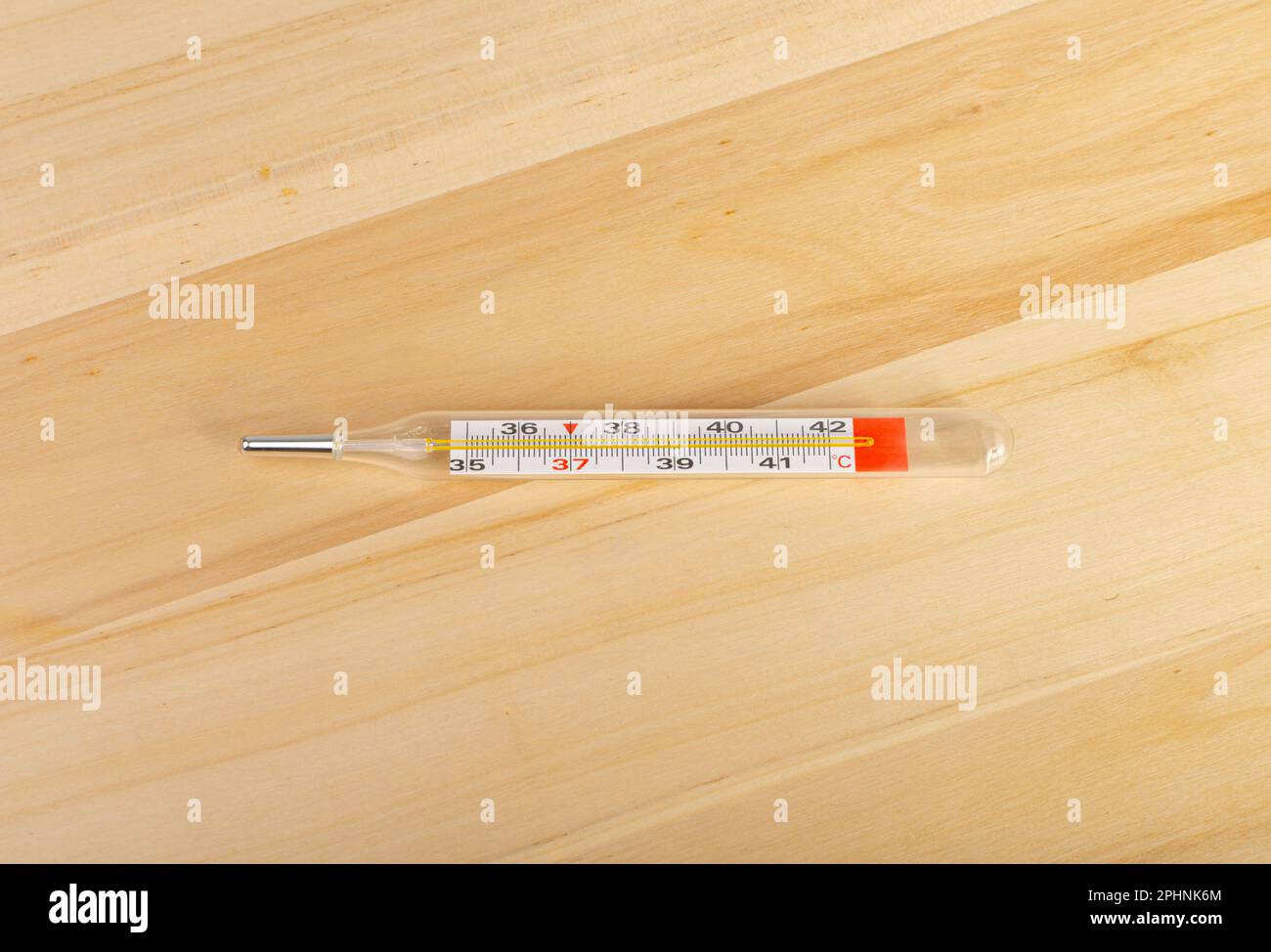 https://c8.alamy.com/comp/2PHNK6M/medical-thermometer-on-wood-background-temperature-measuring-fever-glass-medical-thermometer-top-view-copy-space-2PHNK6M.jpg