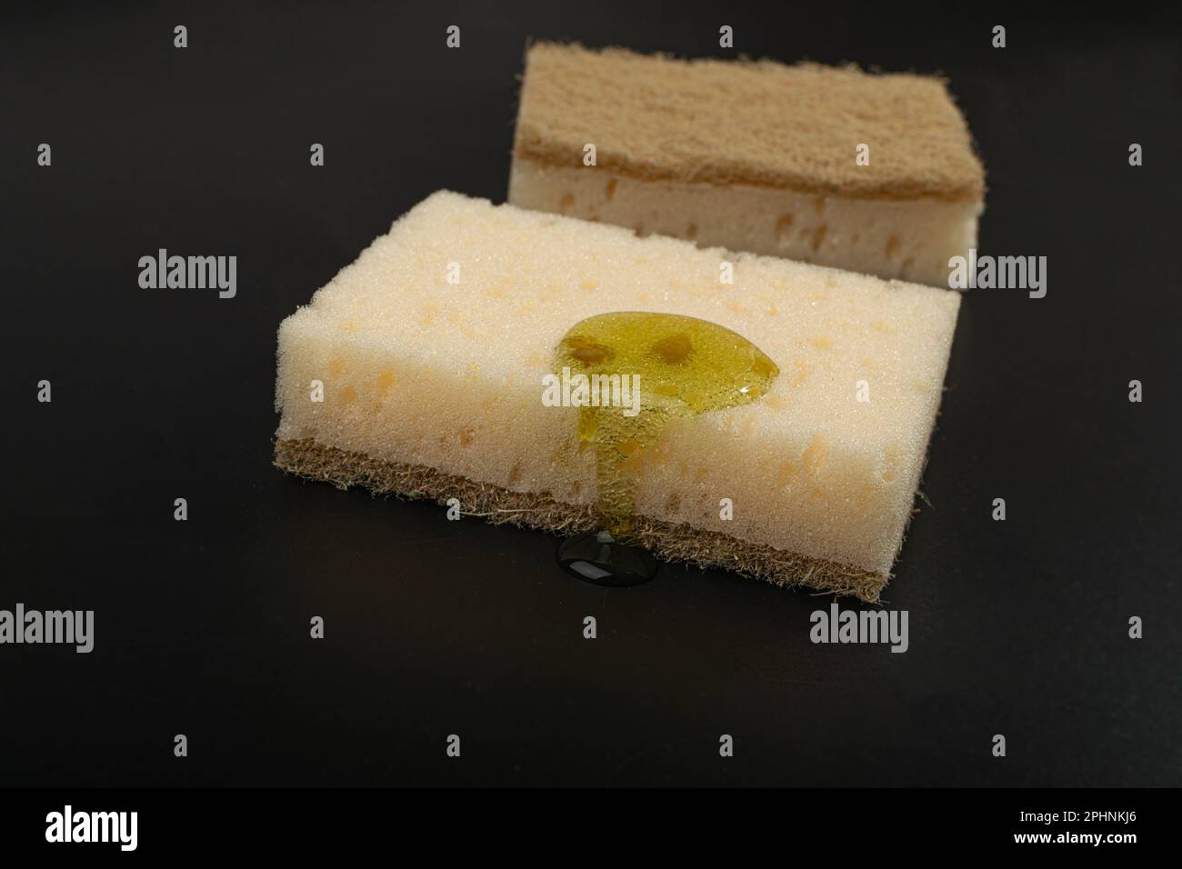 Natural Soapy Sponge with Detergent Drop, Liquid Soap on Eco Brown Sponges on Black Background, Copy Space Stock Photo