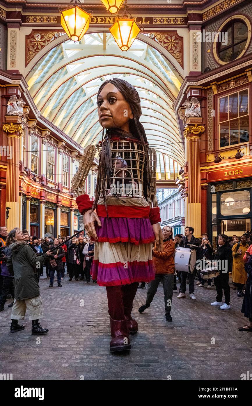 London, UK.  29 March 2023.  Little Amal, a 3.5m puppet of a 10 year old Syrian refugee girl, takes a walk around Leadenhall Market in the City of London to raise fund for displaced children, including those affected by the recent earthquakes in Turkey and Syria.  Starting her journey last year at the Syrian border, Amal has become a global symbol of human rights, especially those of young refugees separated from their families.  Little Amal will continue her walk over the weekend in London and Brighton.  Credit: Stephen Chung / Alamy Live News Stock Photo