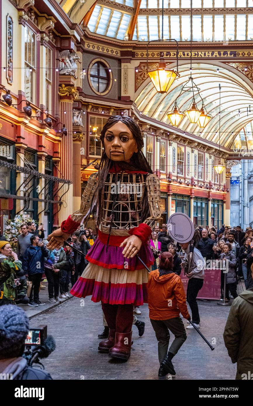 London, UK.  29 March 2023.  Little Amal, a 3.5m puppet of a 10 year old Syrian refugee girl, takes a walk around Leadenhall Market in the City of London to raise fund for displaced children, including those affected by the recent earthquakes in Turkey and Syria.  Starting her journey last year at the Syrian border, Amal has become a global symbol of human rights, especially those of young refugees separated from their families.  Little Amal will continue her walk over the weekend in London and Brighton.  Credit: Stephen Chung / Alamy Live News Stock Photo