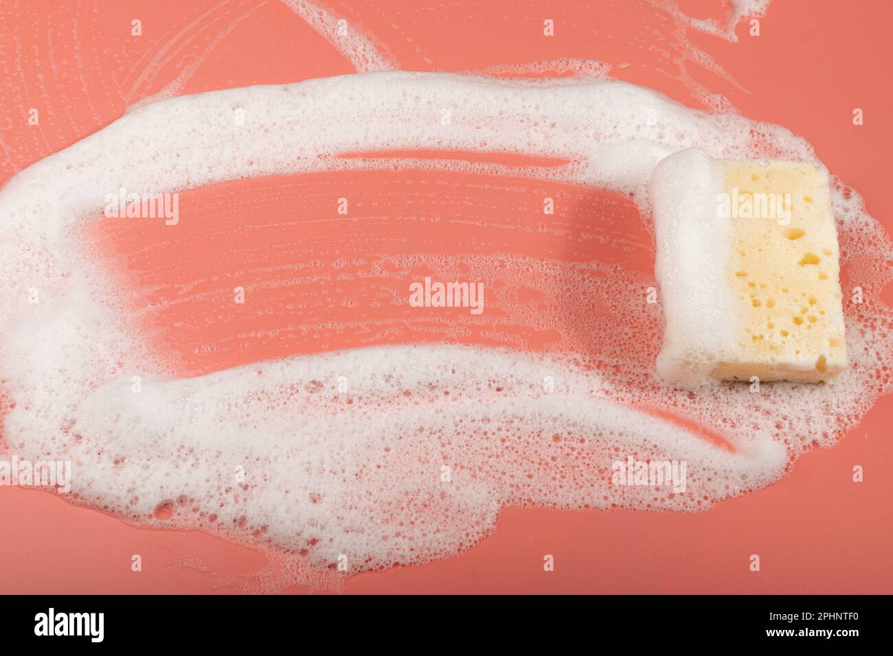 Natural Soapy Sponge with Foam, Eco Brown Sponges, Eco Friendly Hygiene Accessory, Scotch Brite Dishwasher on Pink Background, Copy Space Stock Photo