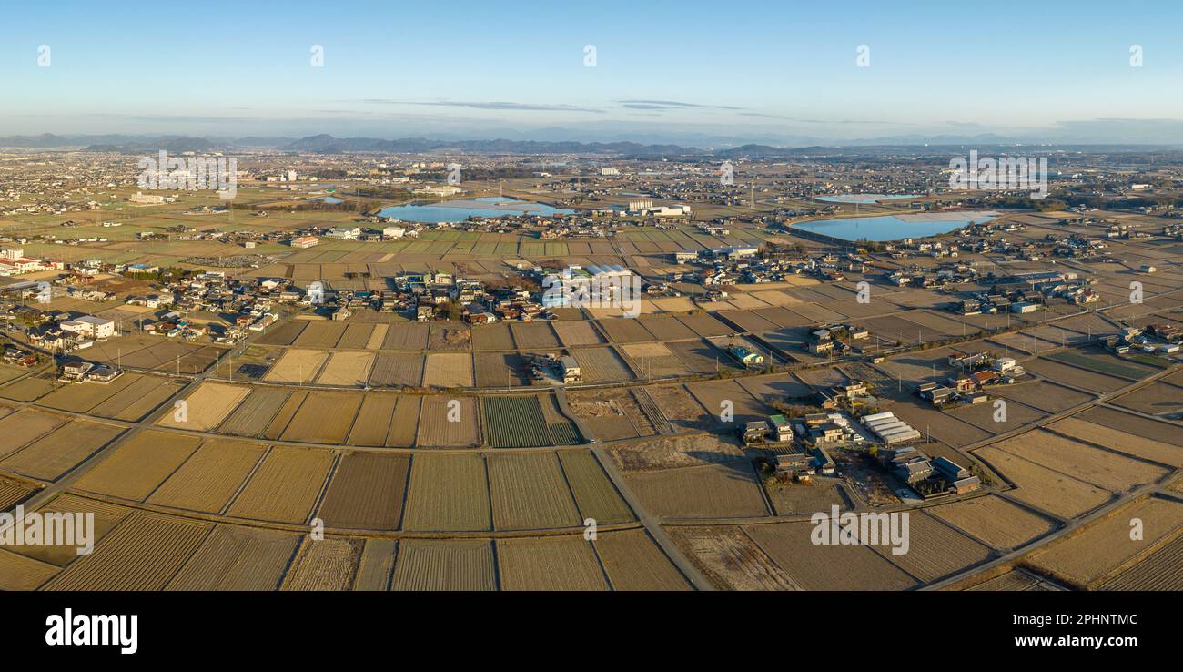 Aerial view of dry farms and fields by homes in rural Japan farming