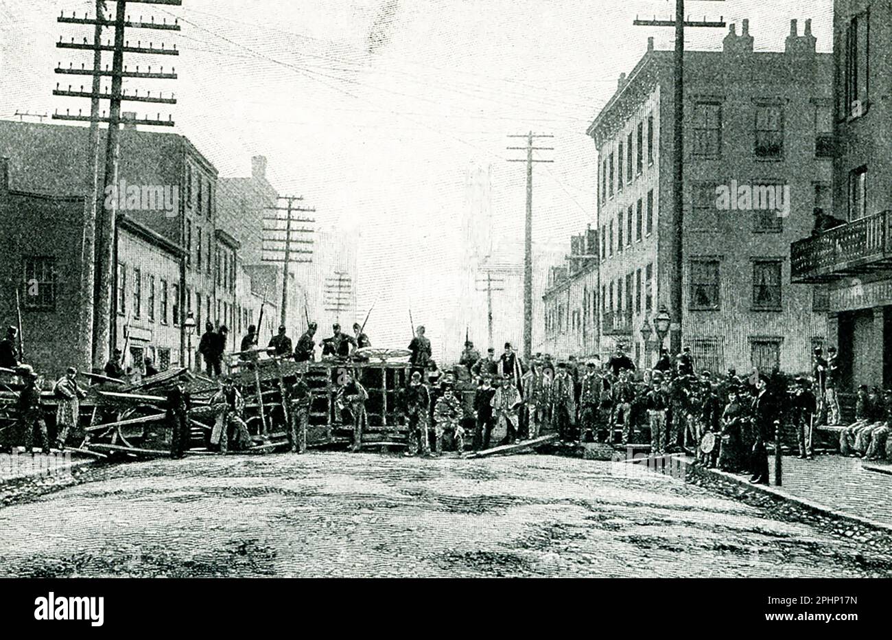 The 1896 caption reads: 'Cincinnati riots of 1884. The Barricade in South Sycamore street  from photograph by Rombach and Groene.' The Cincinnati riots of 1884, also known as the Cincinnati Courthouse riots, were caused by public outrage over the decision of a jury to return a verdict of manslaughter in what was seen as a clear case of murder Stock Photo
