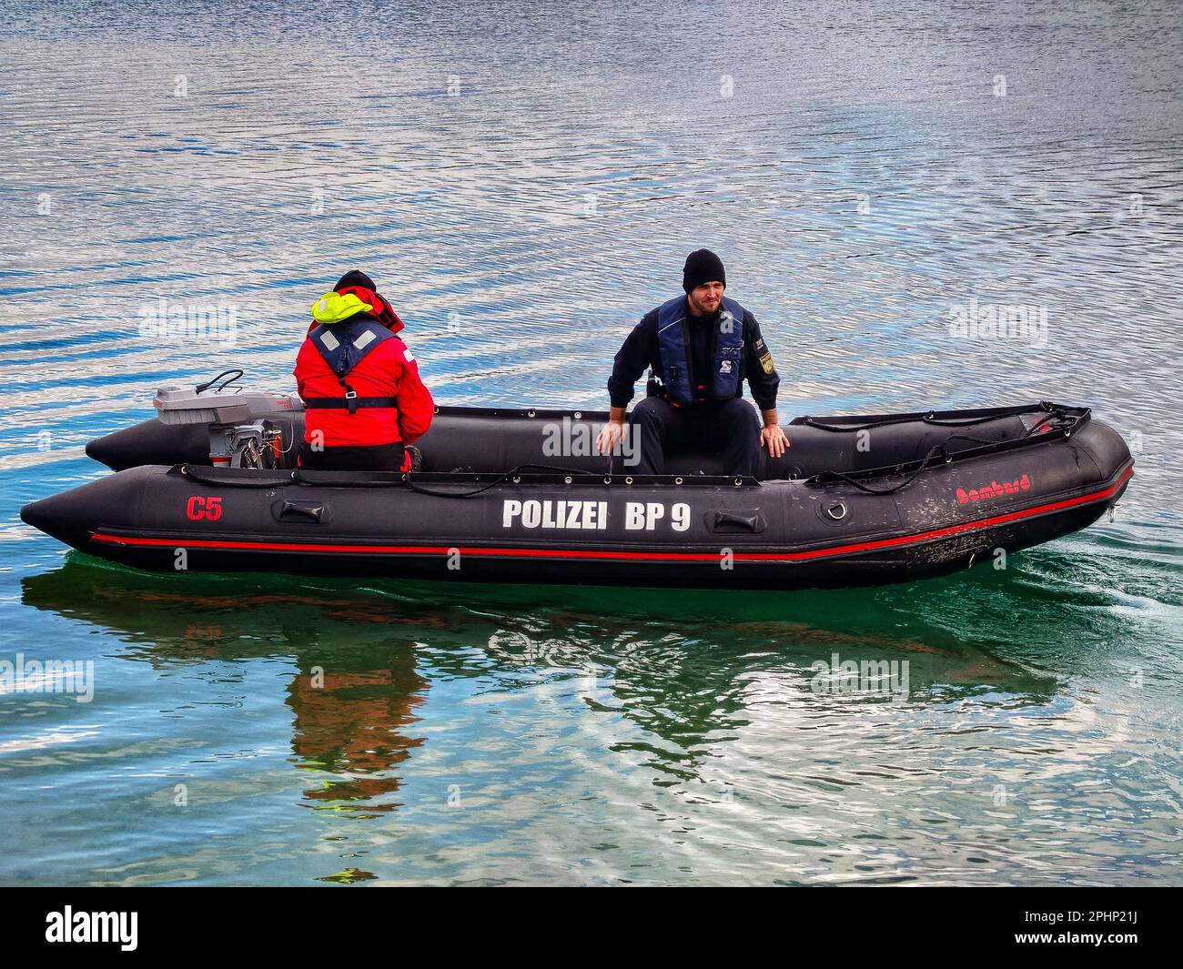 March 28, 2023, Munich, Bavaria, Germany: A Bavarian Police boat newly equipped with electric motors which the police raved about, seeing the performance as perfect for the application and a ''good investment in their health and in the environment''. Members of the Dachau Bereitschaftspolizei (Dachau Police) carried out winter diver training at Munich's Langwiedersee. During the sessions, police took advantage of the frigid conditions to find target items underwater and understand the effects the cold has on the body, spatial awareness, finger dexterity, and endurance. The police also tested t Stock Photo