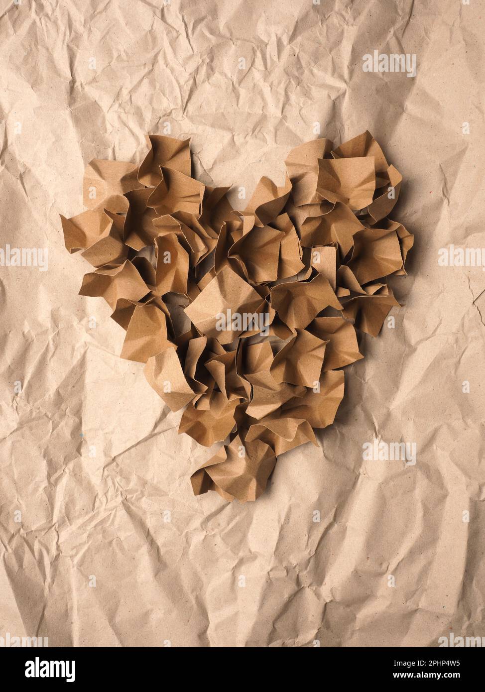 Heart shape made from recycled paper packaging material on a crushed