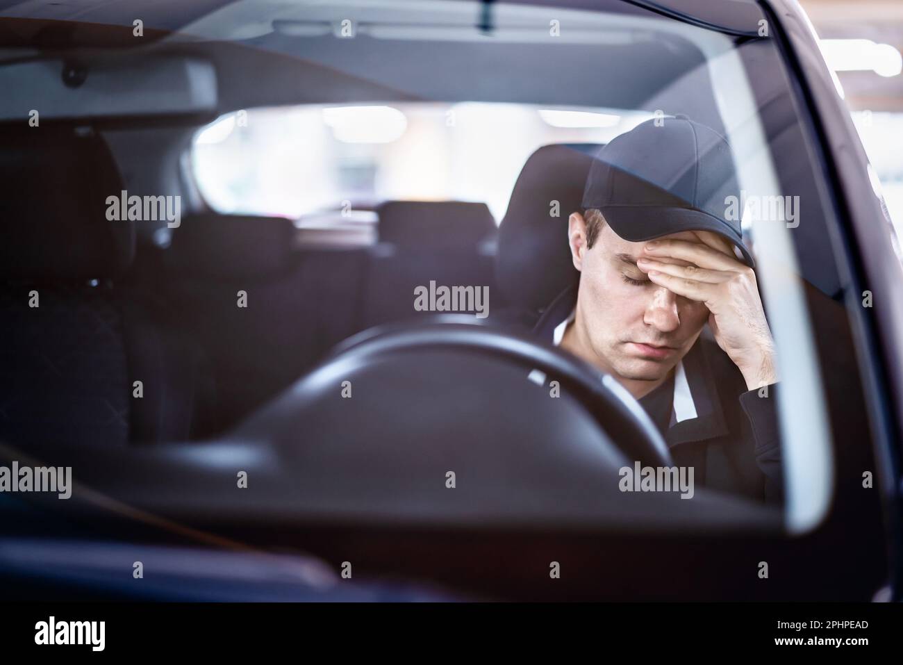 Sad man in car. Accident in traffic. Tired sleepy driver. Sick with headache or migraine. Anxiety, stress, despair or depression. Stock Photo