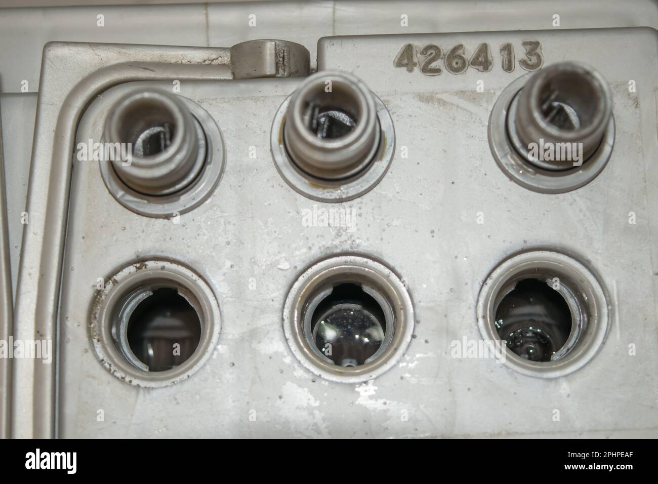 Car battery charging. Gray battery with caps unscrewed Stock Photo Alamy