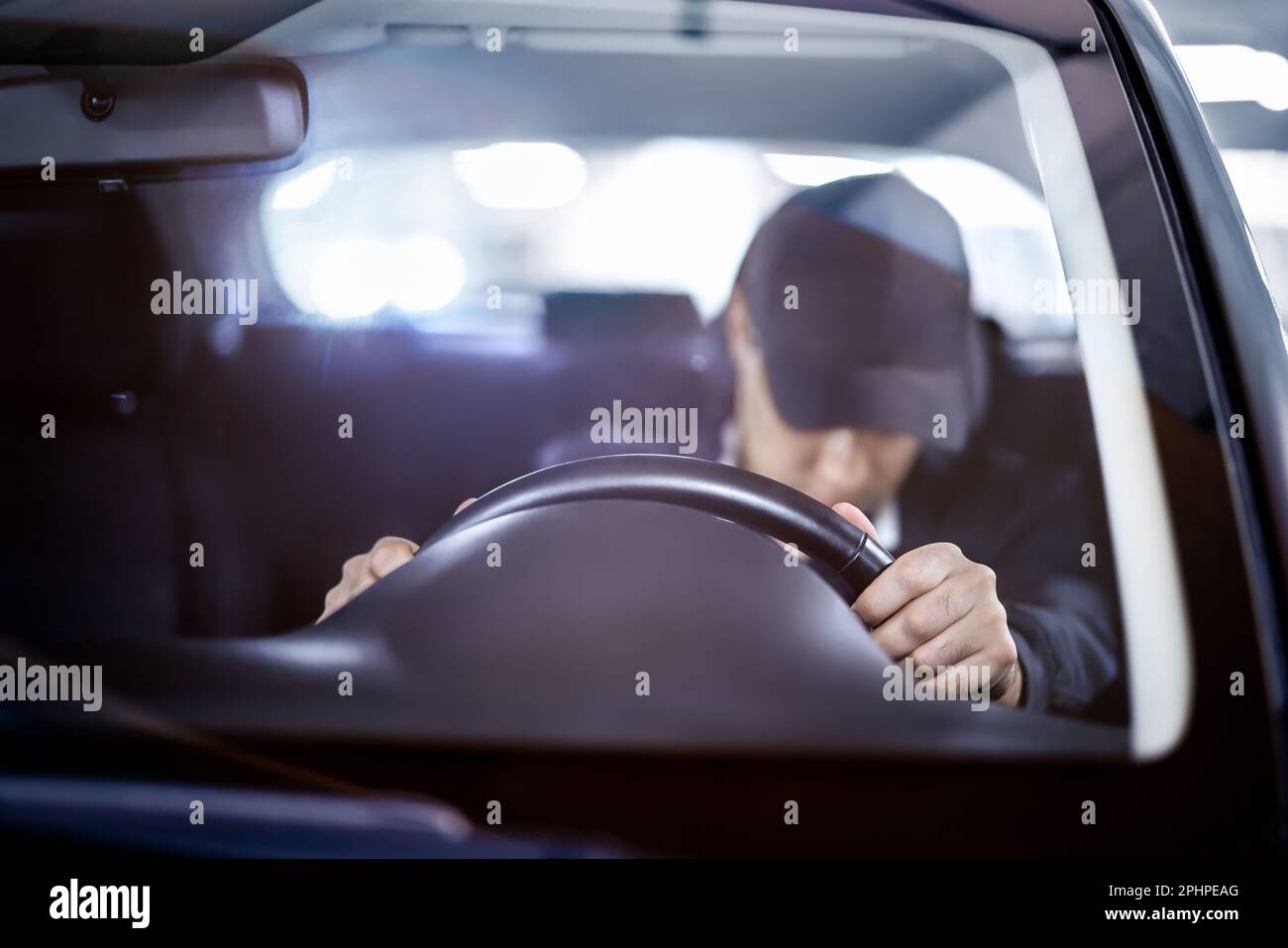 Tired and sleepy driver. Drowsy man driving car. Person sleeping in traffic. Accident or crash. Drunk person, alcohol law violation, DUI. Stock Photo