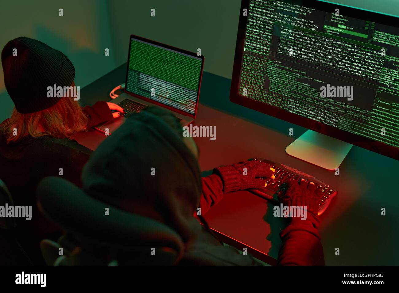 Anonymous people using computer and programming to break code. Cyber security threat. Internet and network security. Access to private information. An Stock Photo