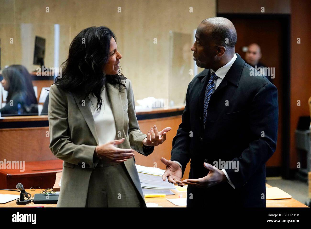 James Ray III, right, speaks with his defense attorney Brooke