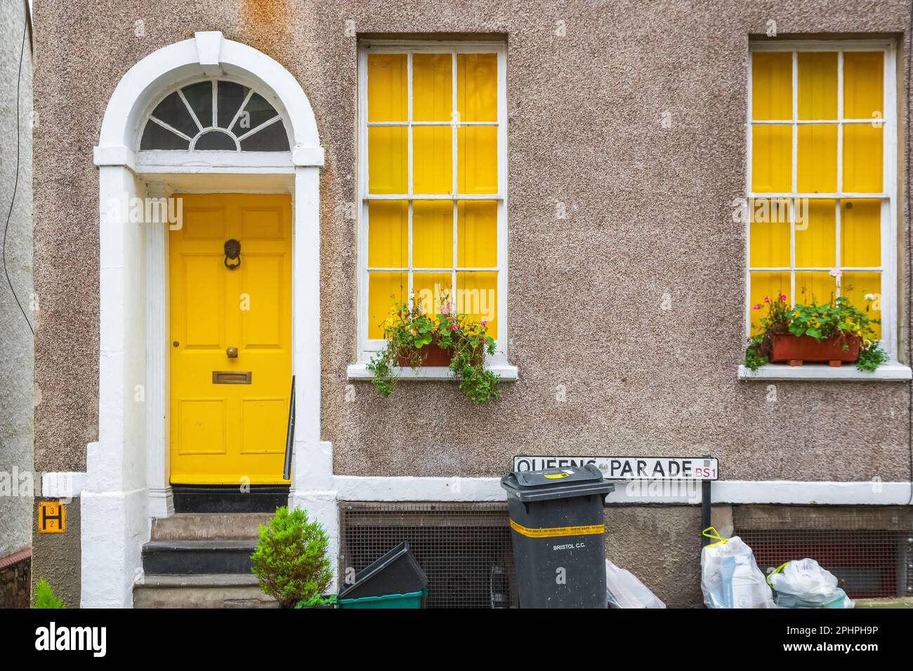 Bristol, England - February 28, 2023 - A Georgian style house frontage decorated with yellow colour and pebbledash wall Stock Photo