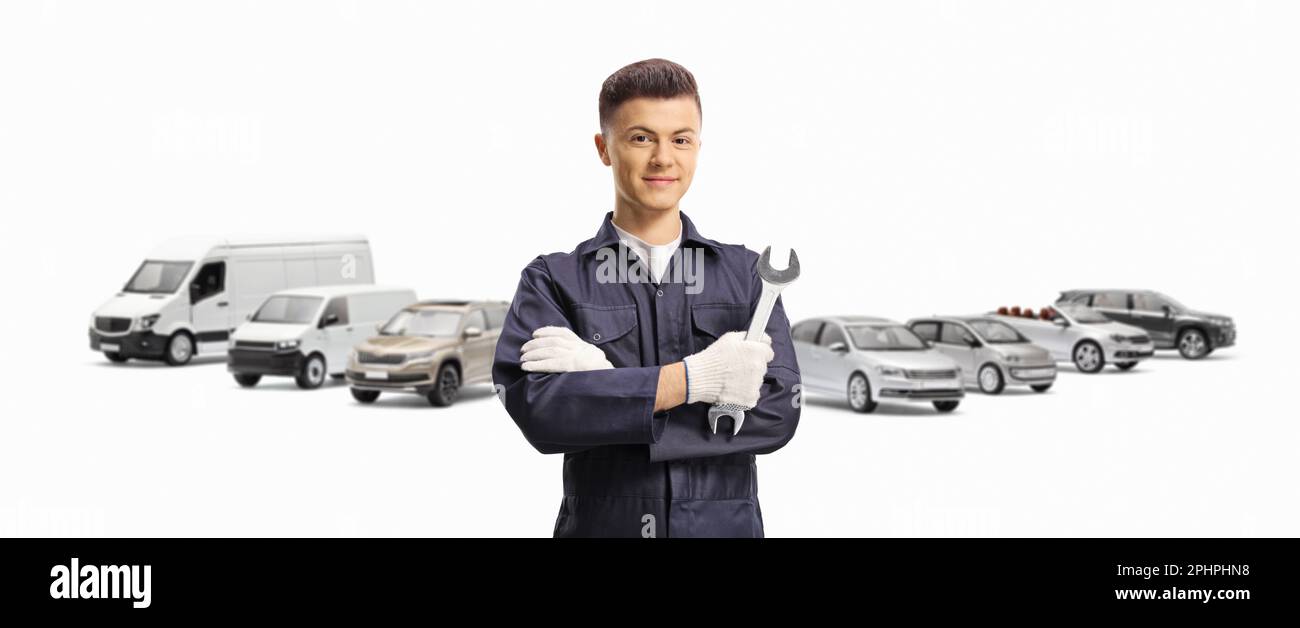 Car mechanic holding a wrench in front of many different vehicles isolated on white background Stock Photo