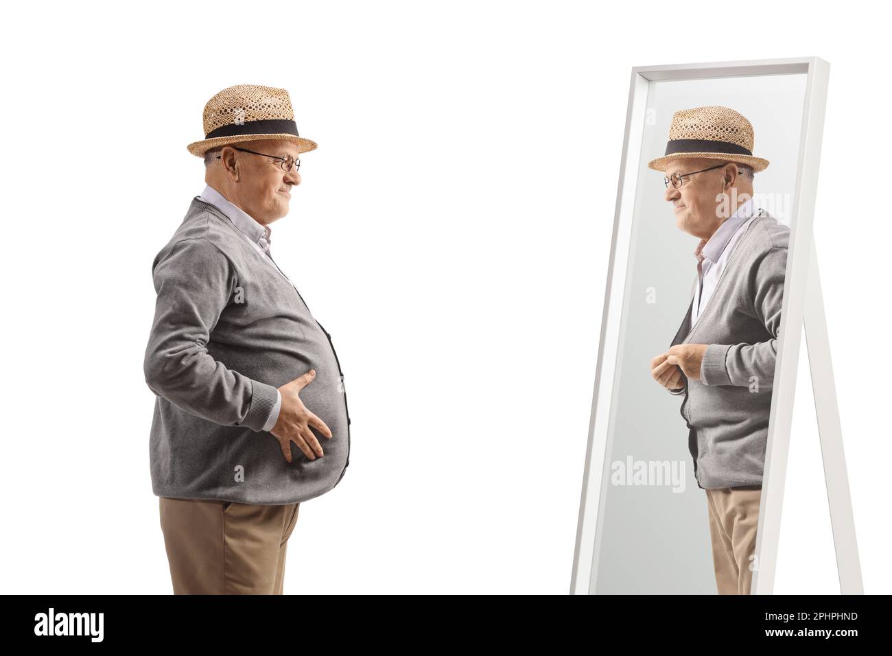 Elderly man with a big belly standing in front of a mirror isolated on white background Stock Photo