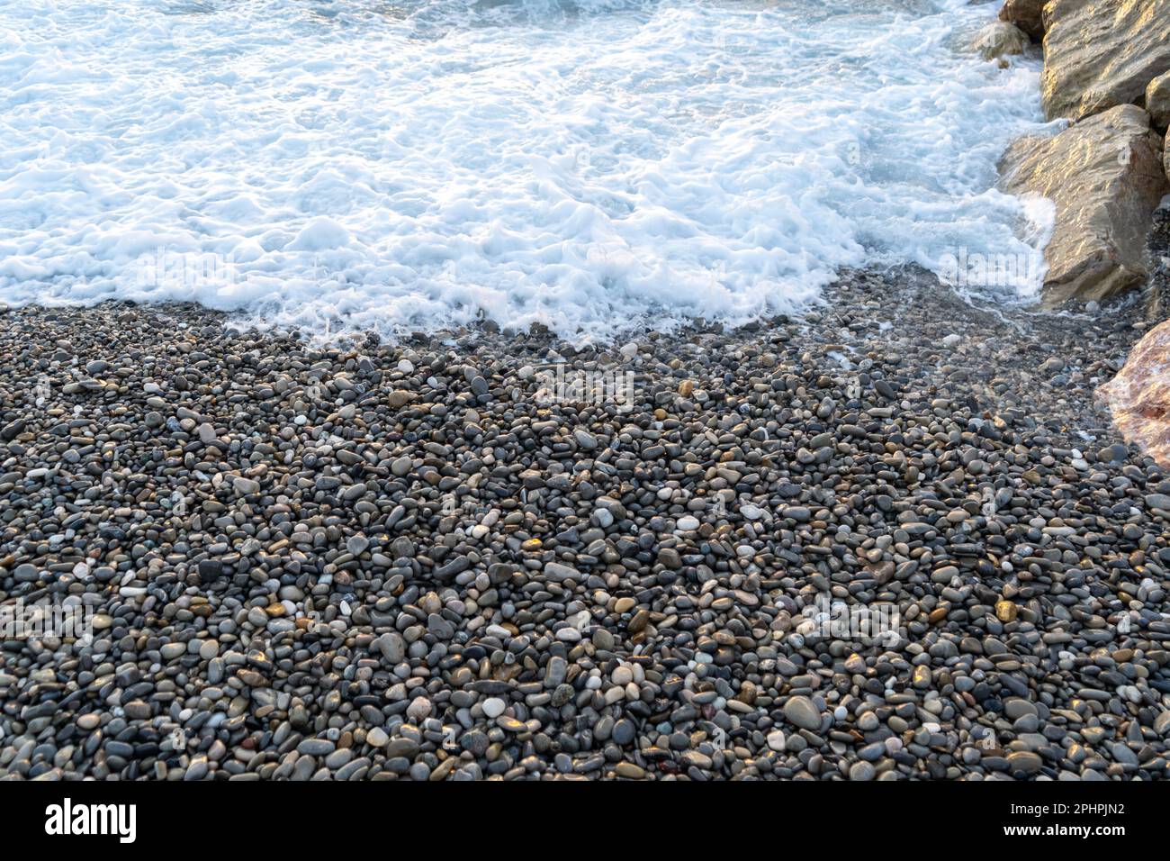 Sea waves on pebble beach texture background. Transparent ocean water ...