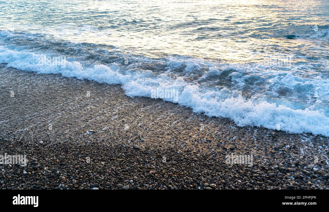 Sea waves on pebble beach texture background. Transparent ocean water ...