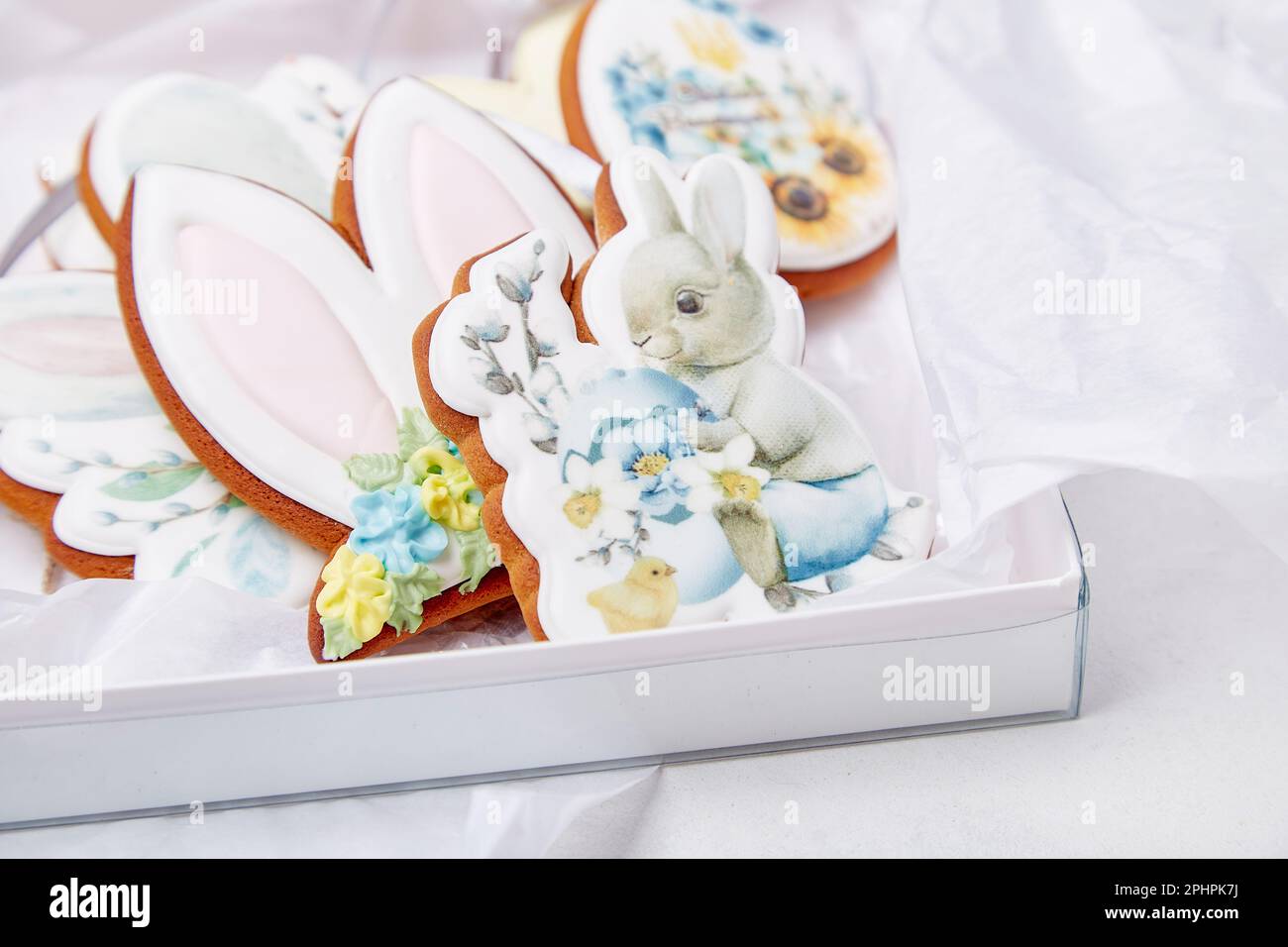 Pastel glazed decorated gift box with Easter cookies close up. Springtime cozy aesthetics background. Stock Photo