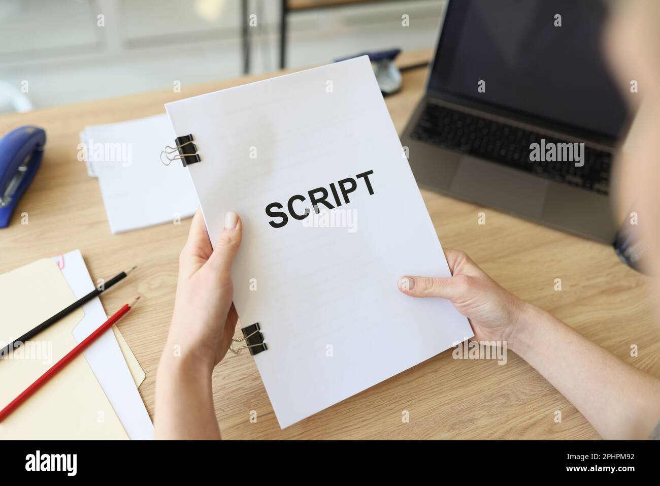 Hands of woman holding script papers for filming movie. Director ...