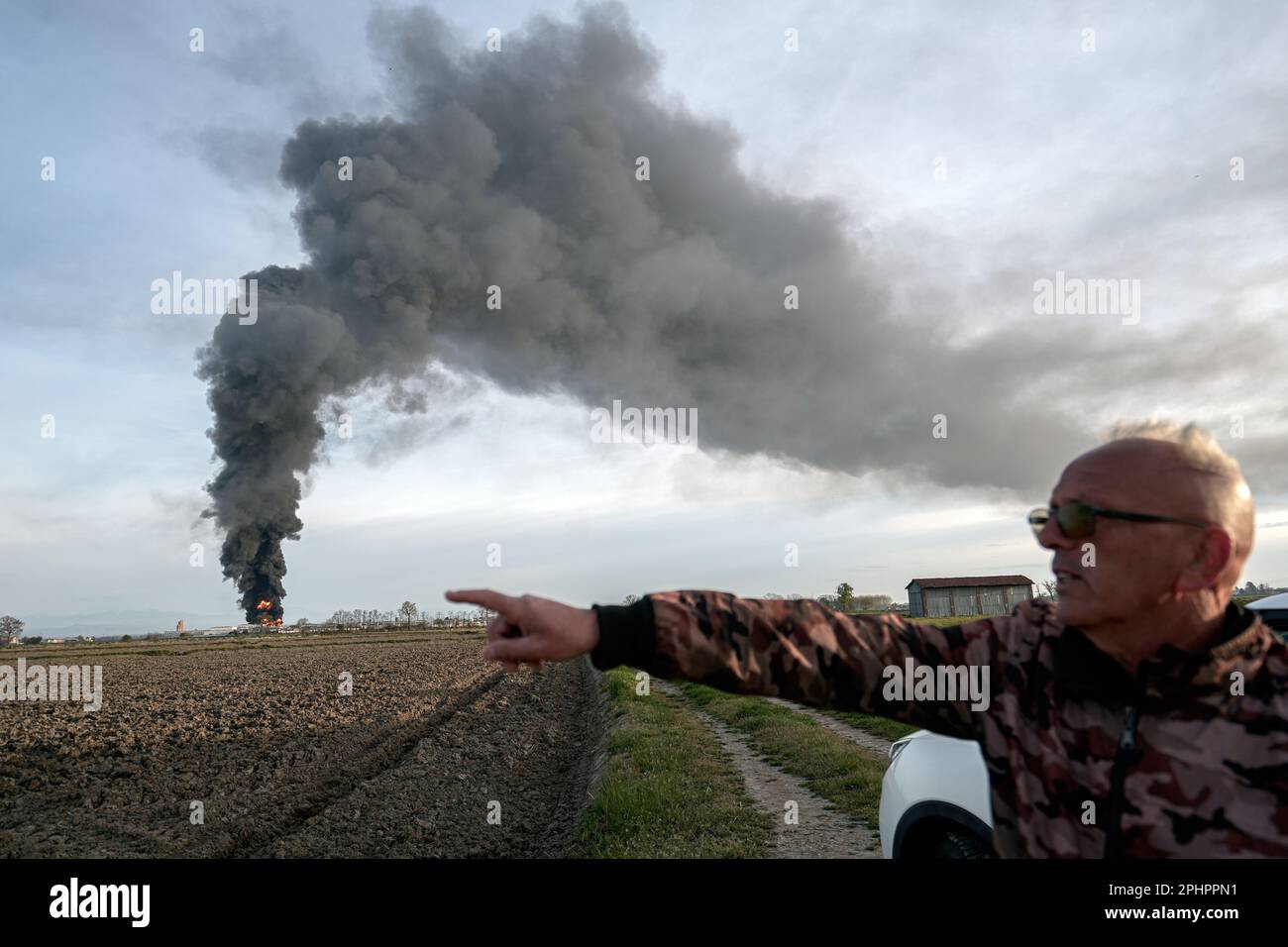 Chemical solvent plant burns down with a black column of toxic smoke. Novara, Italy - March 2023 Stock Photo