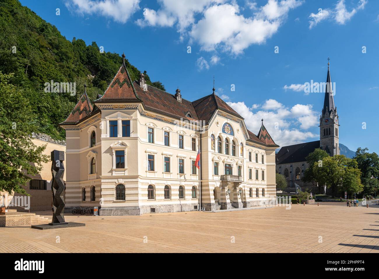 View of Vaduz, the capital of Liechtenstein. On the left, the government building, on the right, the St. Florin Cathedral Stock Photo