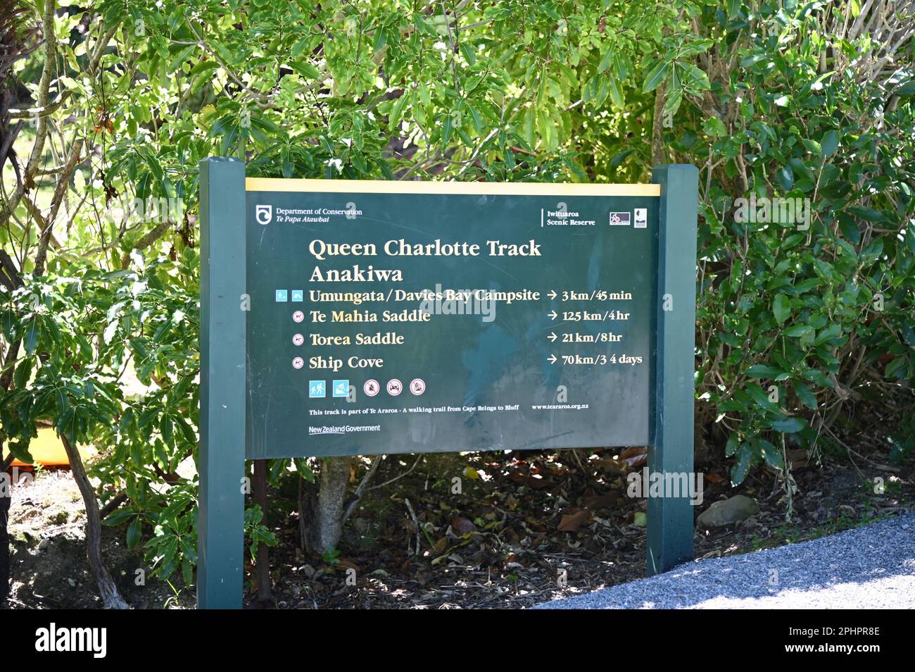 The Department of Conservation (DOC) sign at Anakiwa marking the start (or finish) of the 70+Km Queen Charlotte Track. The track ends at Ship Cove. Stock Photo