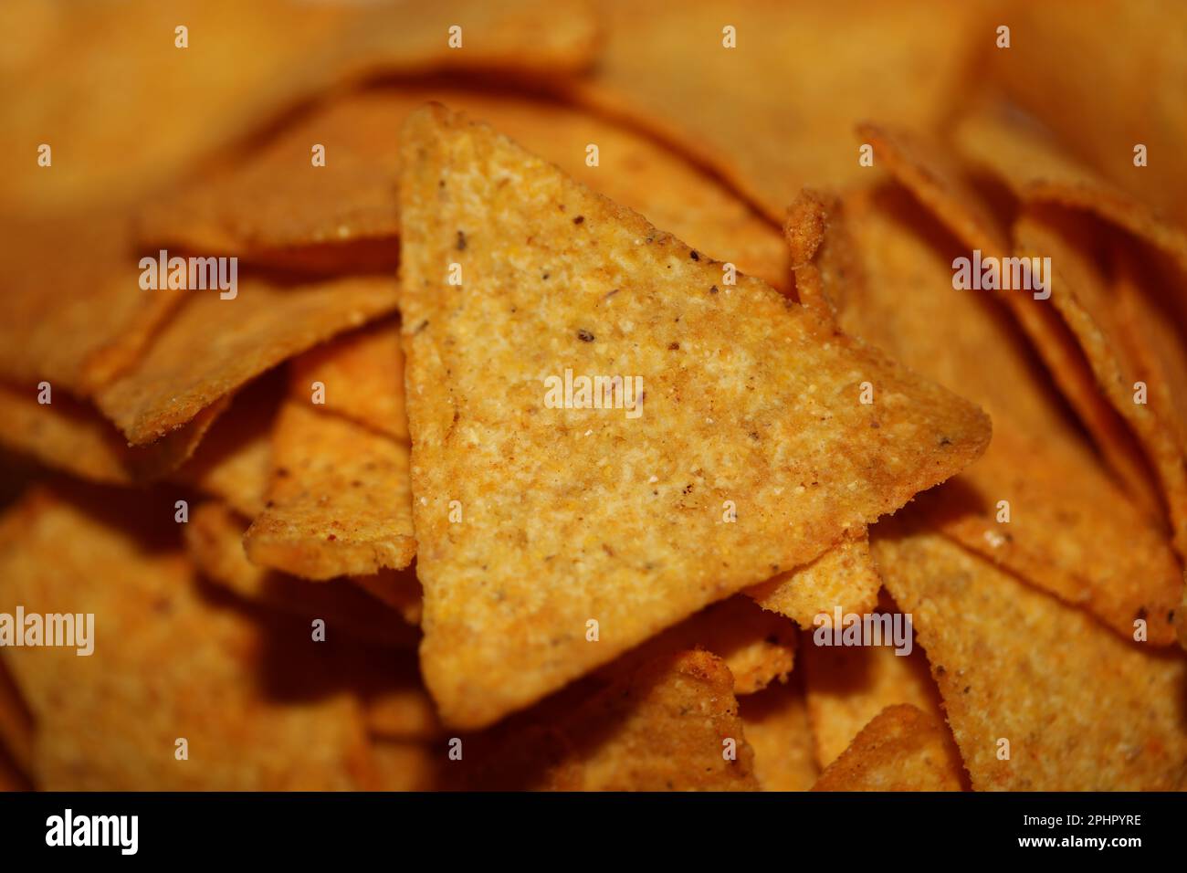 Homemade tortilla spicy chips made with flat bread and baked in oven close up macro background
