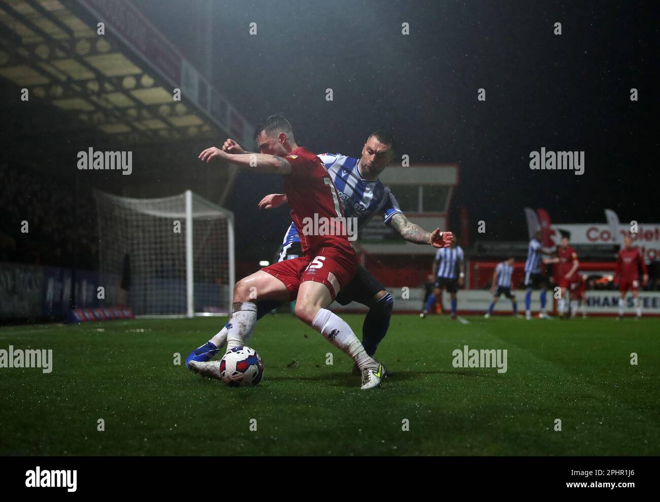 Sheffield Wednesday's Jack Hunt (right) and Cheltenham Town's Will Ferry battle for the ball during the Sky Bet League One match at the Completely-Suzuki Stadium, Cheltenham. Picture date: Wednesday March 29, 2023. Stock Photo